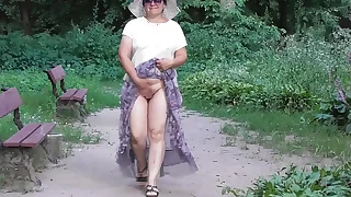 Wife in transparent dress in public woodland